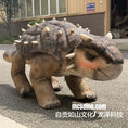 Carica l'immagine nel visualizzatore della galleria, Dinosaur costume on a person walking outdoors with a building in the background