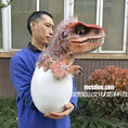 Load image into Gallery viewer, Person holding a dinosaur toy emerging from an egg