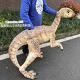 Load image into Gallery viewer, Person holding a large dinosaur model on a street