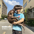 Load image into Gallery viewer, Person holding a large model of a dinosaur in an urban setting