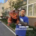 Load image into Gallery viewer, Person holding a dinosaur toy in front of a building
