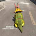 Carica l'immagine nel visualizzatore della galleria, Dinosaur costume with red and yellow accents on a road