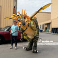 Load image into Gallery viewer, Person standing next to a large dinosaur costume on a street