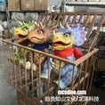 Load image into Gallery viewer, Four colorful dinosaur puppets in a wooden crate with 'mcsdino.com' branding.
