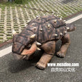 Carica l'immagine nel visualizzatore della galleria, Dinosaur costume on a person walking on a road
