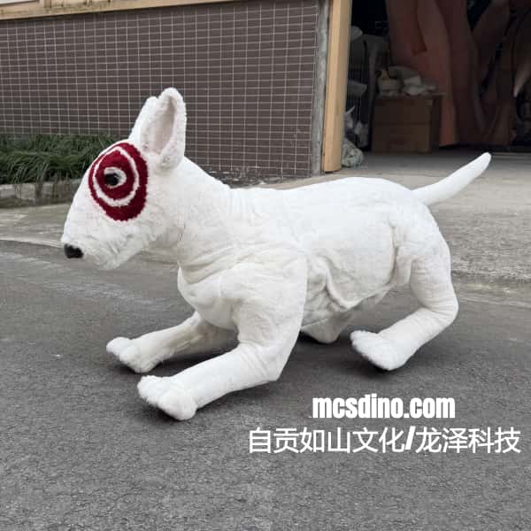 White plush dog toy with red and black patch on face on a concrete surface