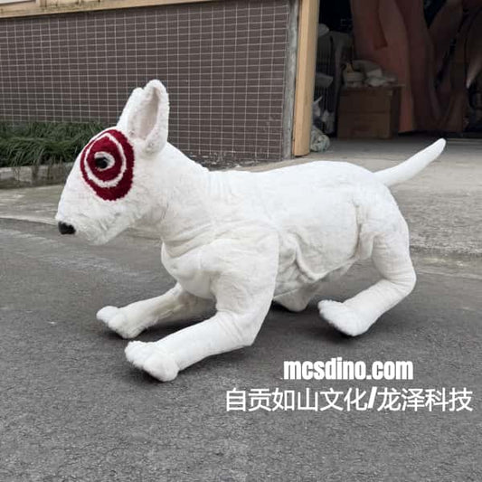 White plush dog toy with red and black patch on face on a concrete surface