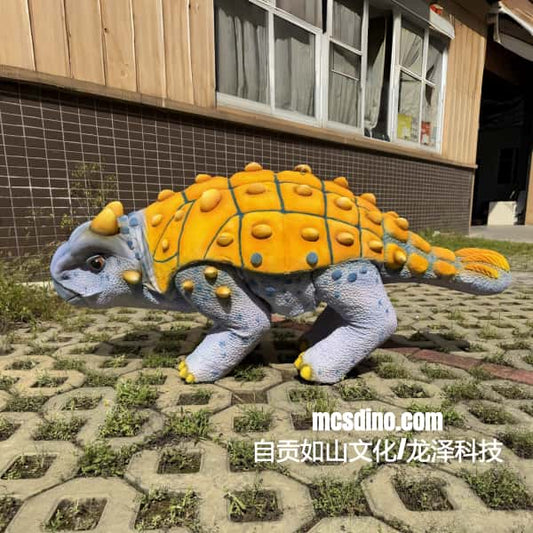Dinosaur statue with yellow shell on a patterned pavement
