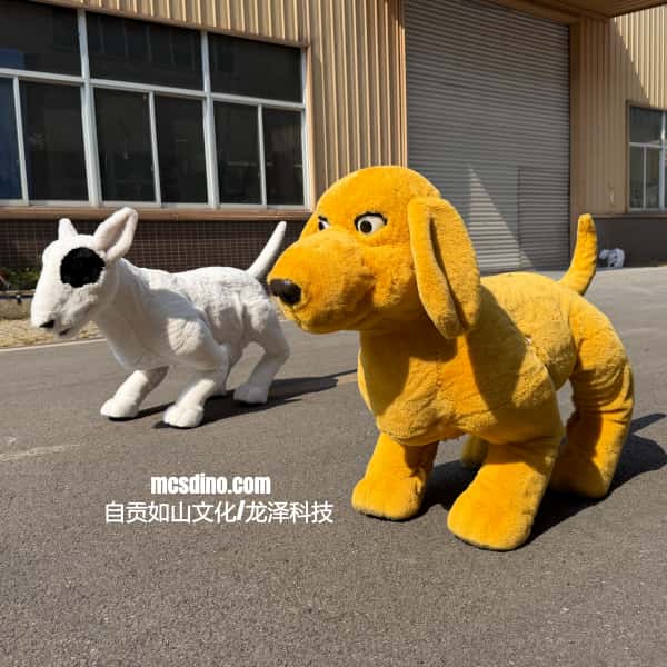 Two plush mascot costumes standing on an outdoor paved area in front of a building. The foreground costume is a large yellow dog with floppy ears and a black nose, and the background costume is a white sheep with a black ear patch.