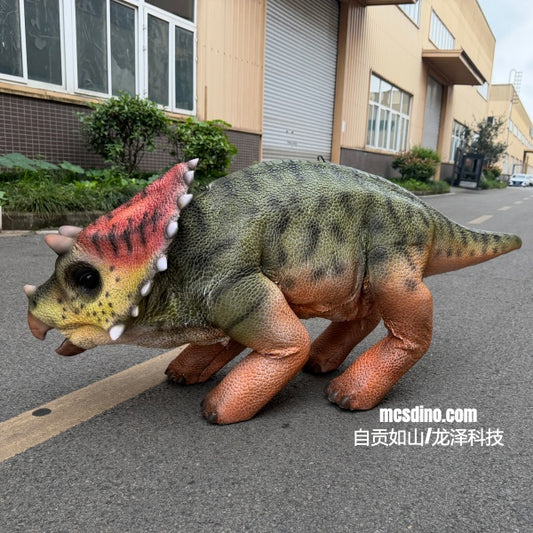 Toy dinosaur model on a street with a building in the background