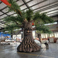 Load image into Gallery viewer, Tree-like sculpture with a face in an indoor setting
