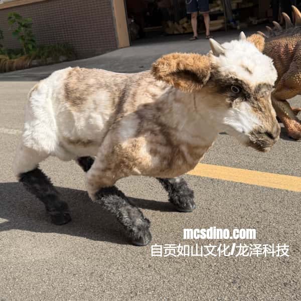 A small dinosaur-themed toy or model animal with a white head, tan and cream body, and dark legs, photographed outdoors on pavement. A watermark reading mcsdino.