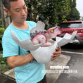 Charger l'image dans la visionneuse de la galerie, Man holding a dinosaur toy in an egg-shaped container outdoors.
