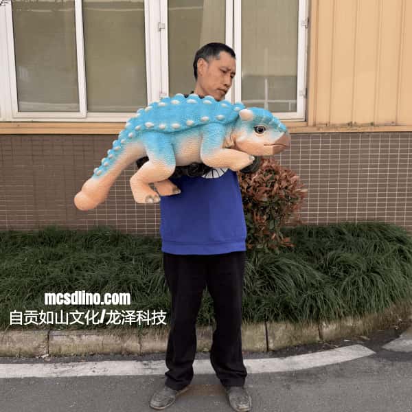 Man holding a large blue and beige dinosaur plush toy outdoors.
