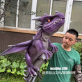 Bild in Galerie-Betrachter laden, Person holding a large purple dragon model outdoors with a building in the background
