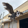 Load image into Gallery viewer, Plush toy resembling a bird of prey on a building roof
