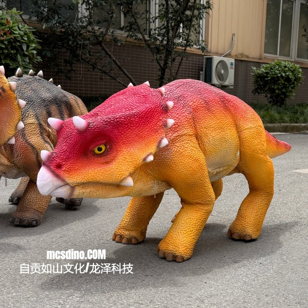 Colorful dinosaur models on a street with a building in the background