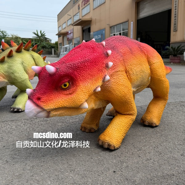 Colorful dinosaur models on a street with a building in the background