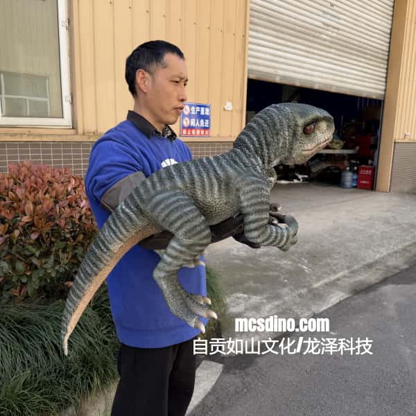 Person holding a large toy dinosaur in front of a building