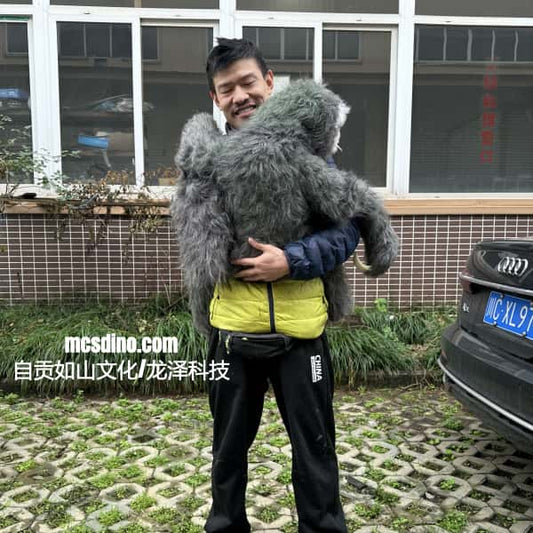 Person holding a large plush toy in front of a building with a car in the background