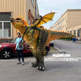 Load image into Gallery viewer, Person standing next to a large dragon costume on a street
