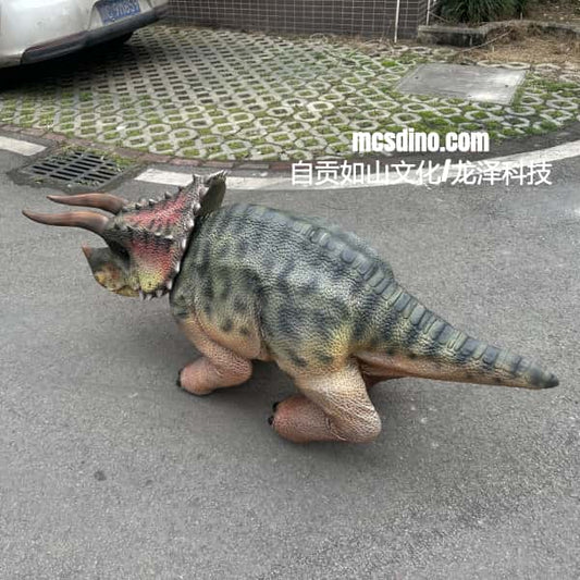 Dinosaur toy on a street with visible branding