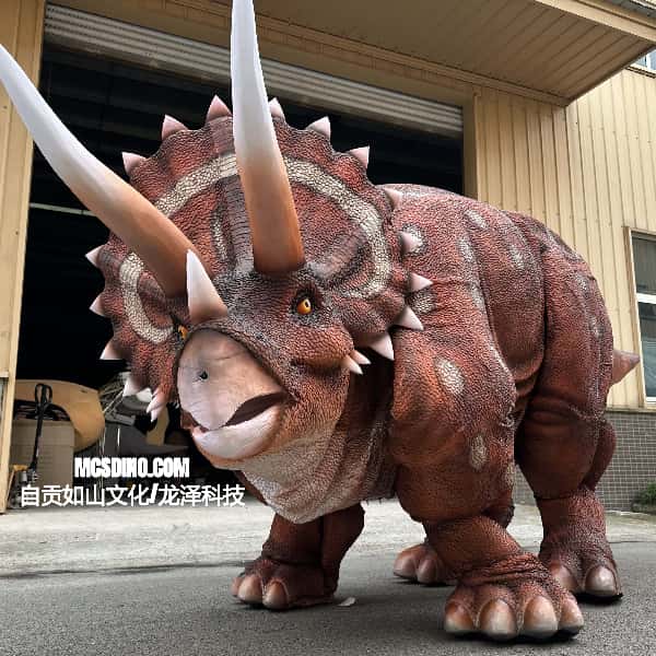 Dinosaur costume with large horns in front of a building