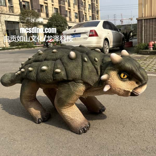 Large dinosaur model on a street with a building and car in the background