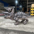 Load image into Gallery viewer, Model of a dinosaur-like creature in an indoor setting with industrial elements.
