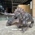 Load image into Gallery viewer, Dinosaur model in a workshop setting with 'mcsdino.com' branding.
