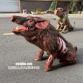 Load image into Gallery viewer, A realistic horror prop pig with exposed ribs and red eyes on an asphalt surface, with a second creature prop in the background. Chinese watermark text 'mcsdino.
