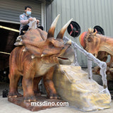 kid riding triceratops Dino ride